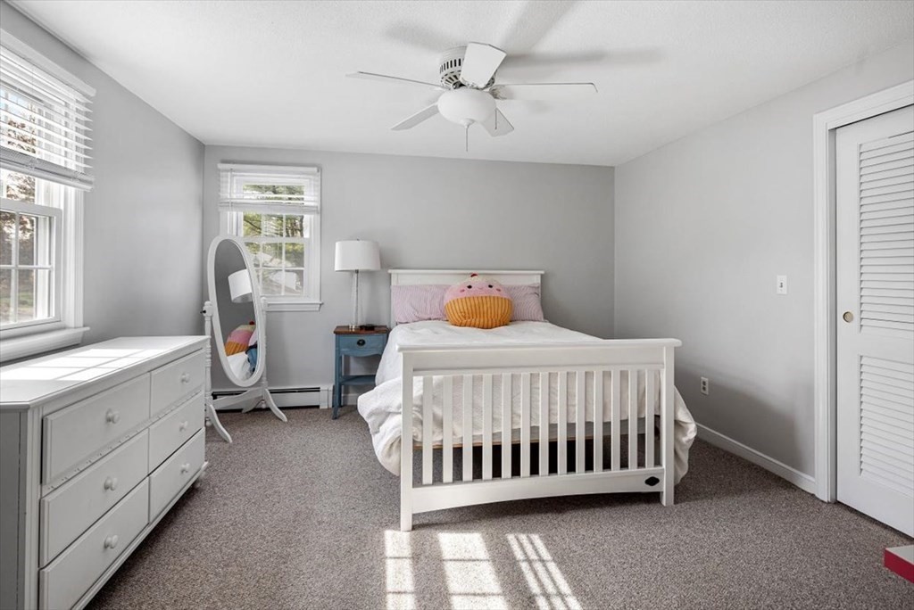 26 Stanford Drive Hingham, MA 02043 - Photo 23 of 37 a bedroom with a bed and a chandelier