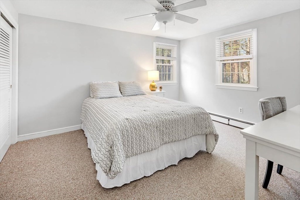 26 Stanford Drive Hingham, MA 02043 - Photo 25 of 37 a bedroom with a bed and a chandelier