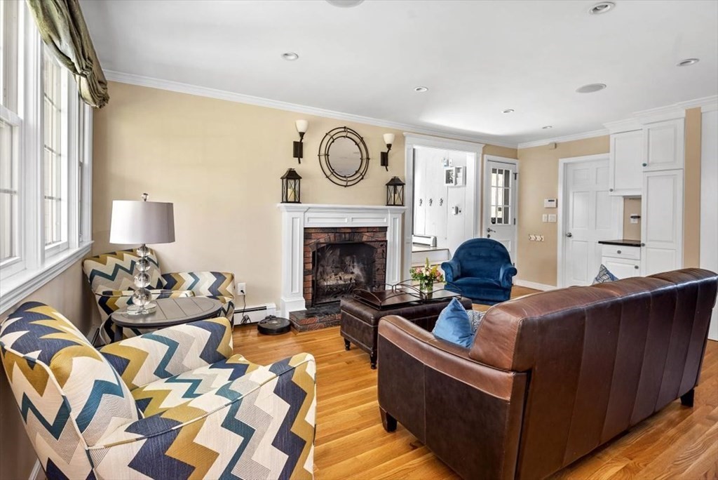 26 Stanford Drive Hingham, MA 02043 - Photo 5 of 37 a living room with furniture a fireplace and a large window