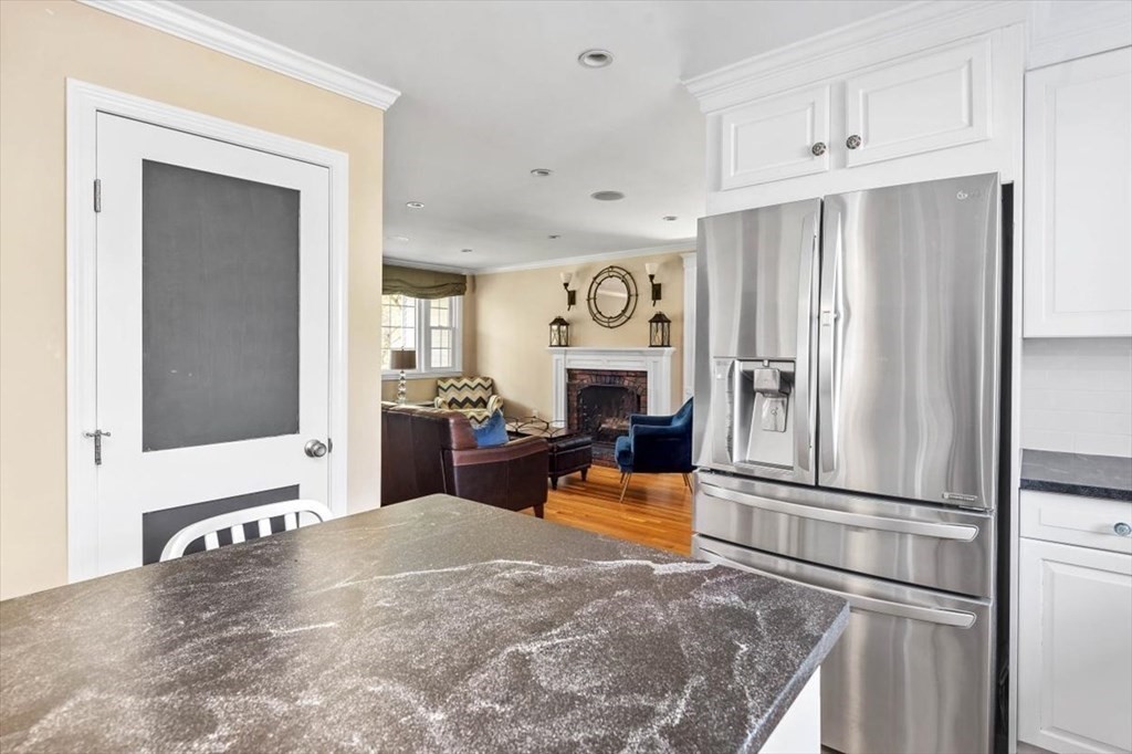 26 Stanford Drive Hingham, MA 02043 - Photo 7 of 37 a kitchen with stainless steel appliances kitchen island granite countertop a refrigerator and a stove top oven