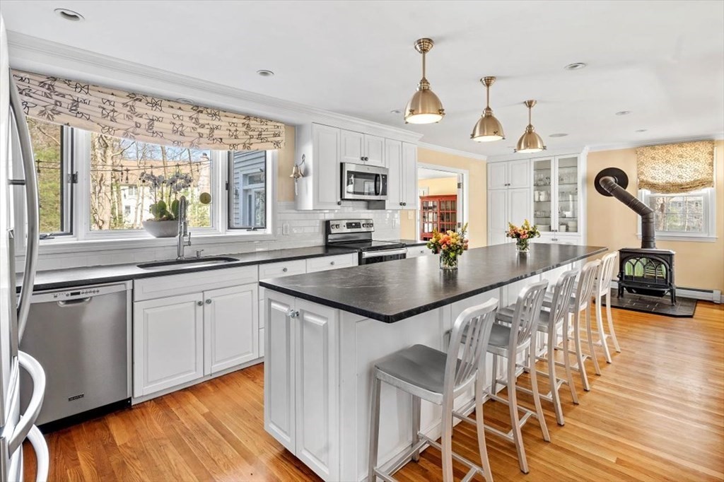 26 Stanford Drive Hingham, MA 02043 - Photo 9 of 37 a open kitchen with granite countertop a sink a counter space dining table and chairs