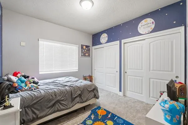a bathroom with a granite countertop sink a toilet a mirror a vanity and shower