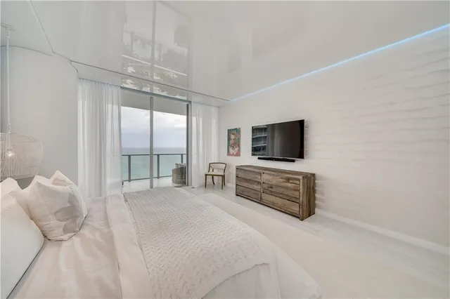 a bedroom with a bed and a large mirror