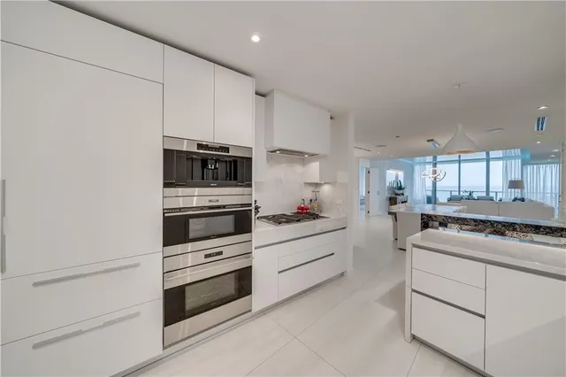 a kitchen with a table chairs sink and cabinets