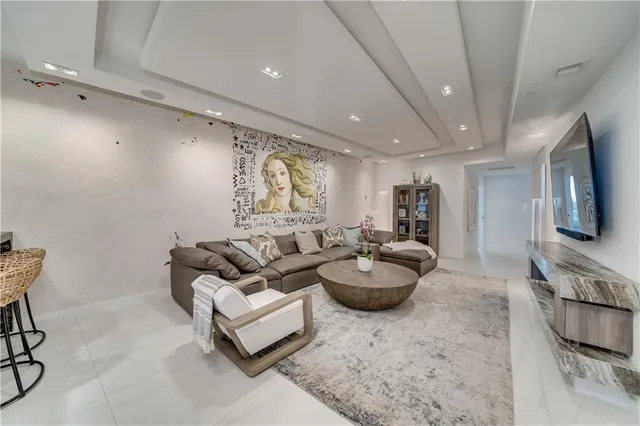 a bedroom with a bed a chandelier and a window