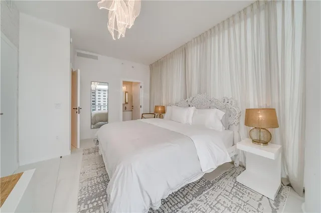 a bedroom with a bed and a large window