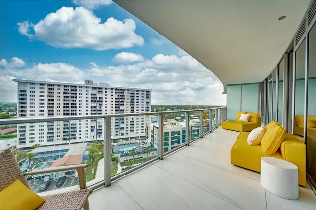 a bedroom with furniture and large windows