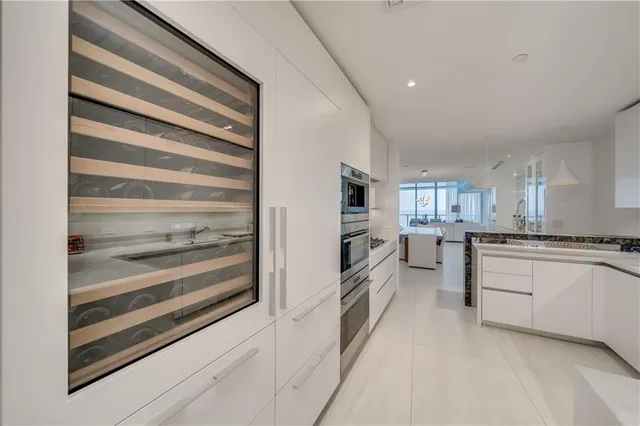 a kitchen with white cabinets and appliances