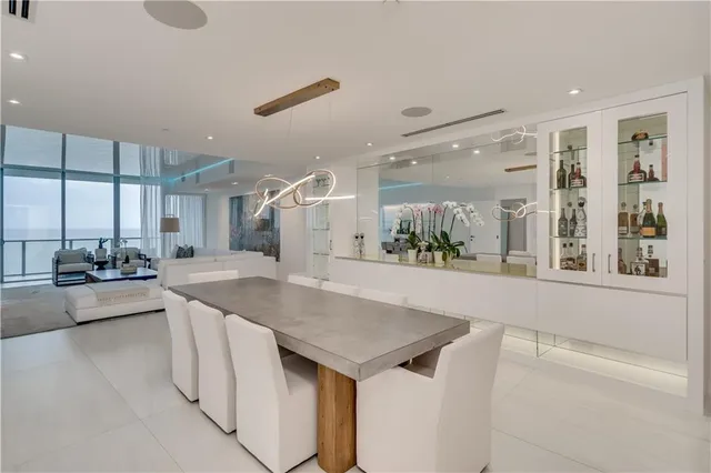 a view of a kitchen island a chandelier and living room view