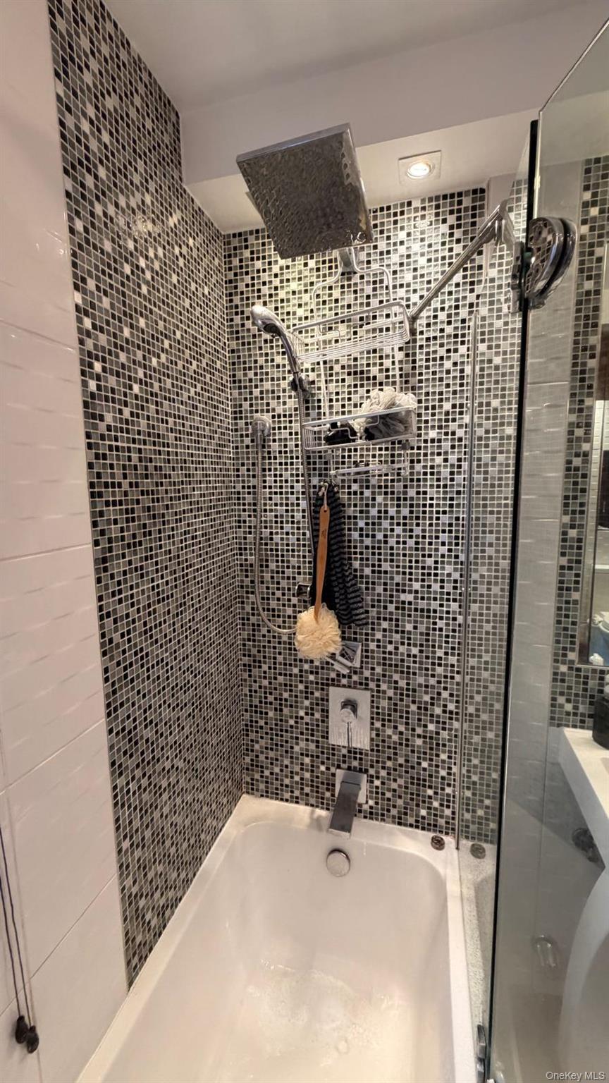 8305 98th Street, Unit 3C Queens, NY 11421 - Photo 16 of 19 a bathroom with a sink and a shower