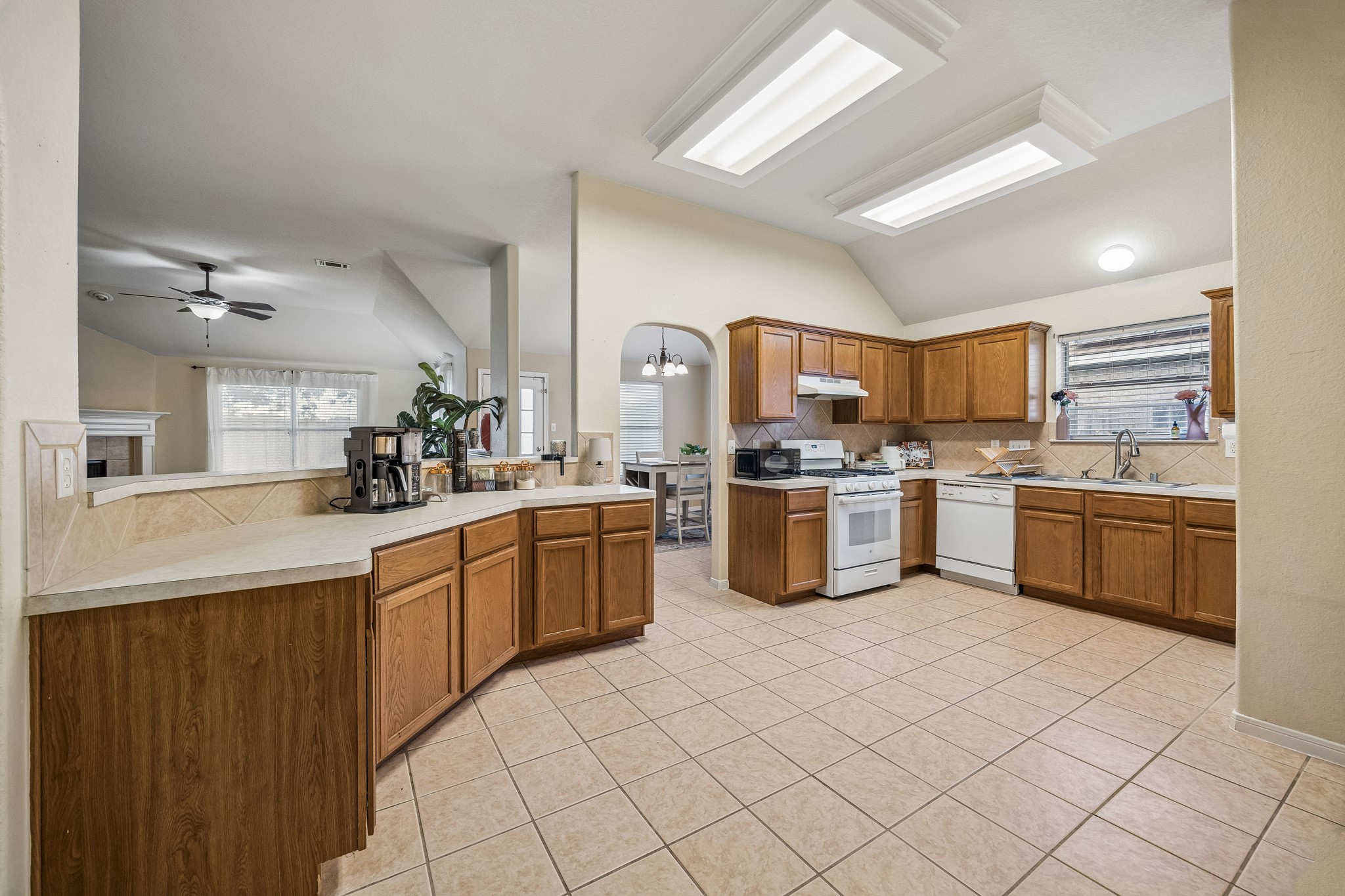 24027 Floragate Drive Spring, TX 77373 - Photo 8 of 21 a kitchen with a sink a counter top space cabinets and stainless steel appliances