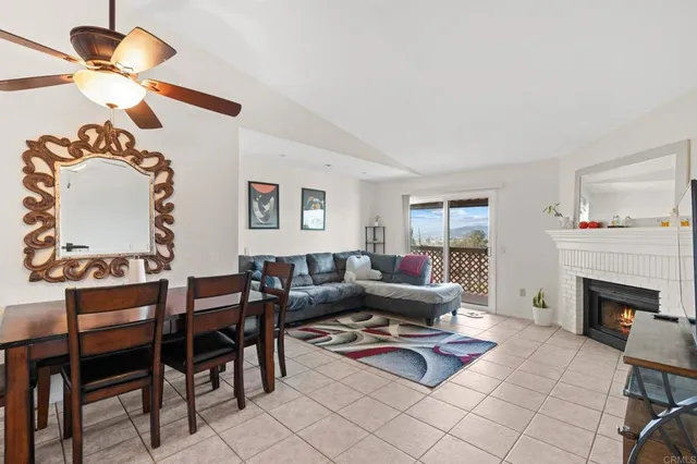 a living room with furniture a fireplace and a chandelier