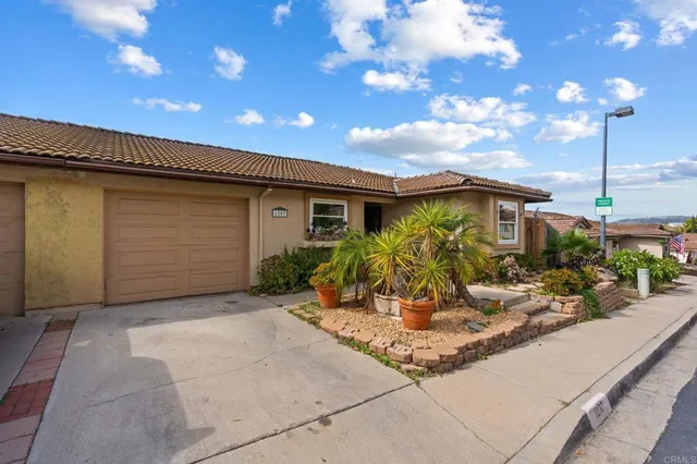 a view of a house with sitting area and garden