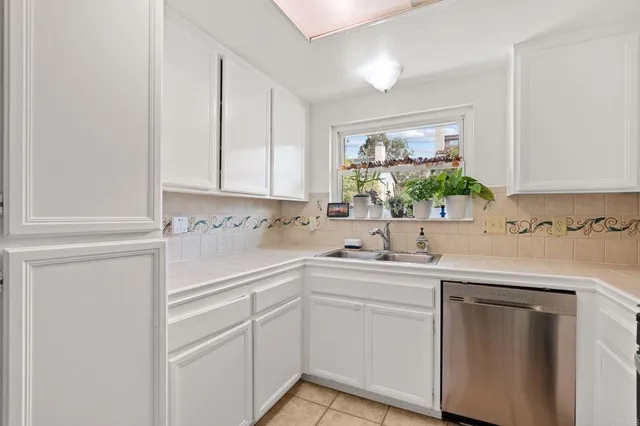 a kitchen with white cabinets and white appliances