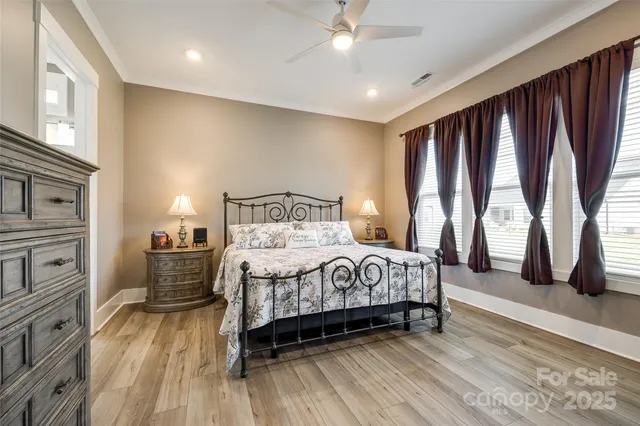 a bedroom with a bed a rug and dresser