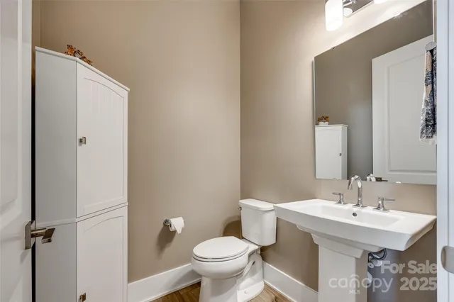 a bathroom with a granite countertop sink and a mirror next to a window