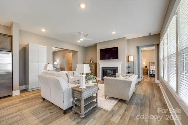 a large kitchen with a large counter top a sink stainless steel appliances and cabinets