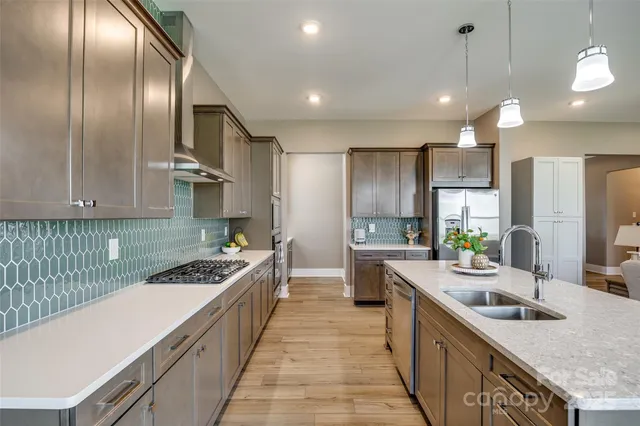 a kitchen with a sink stainless steel appliances and cabinets
