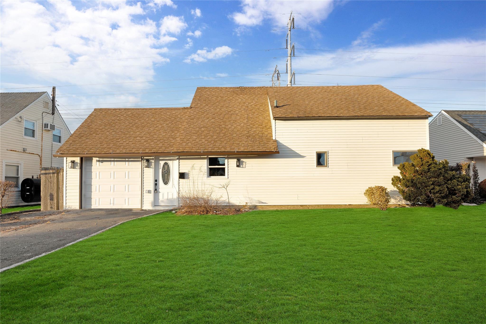 37 Mallard Road Levittown, NY 11756 - Photo 1 of 1 View of front of home with a garage and a front lawn
