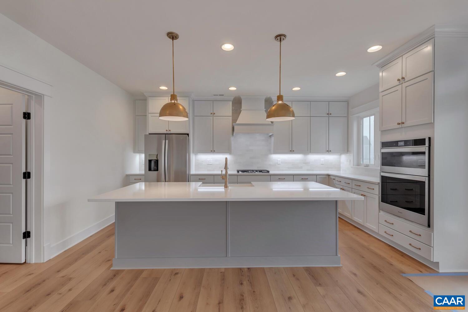 3031 Eagle View Charlottesville, VA 22903 - Photo 27 of 75 a kitchen with kitchen island a sink stainless steel appliances and cabinets
