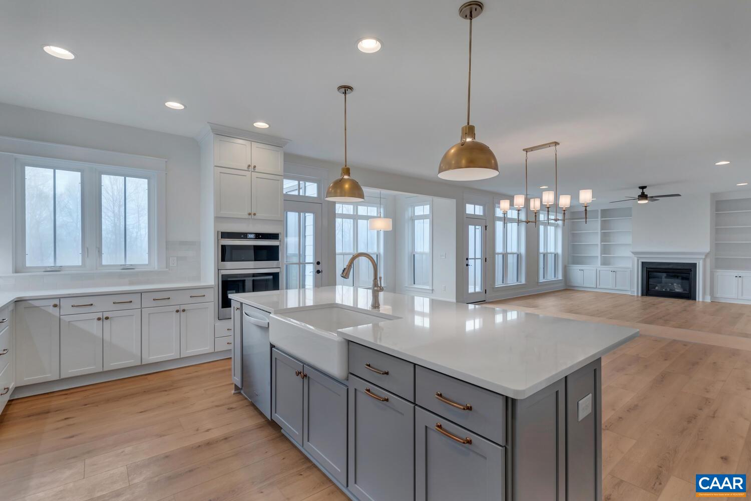 3031 Eagle View Charlottesville, VA 22903 - Photo 31 of 75 a kitchen with kitchen island granite countertop a stove a sink a center island and a wooden floor