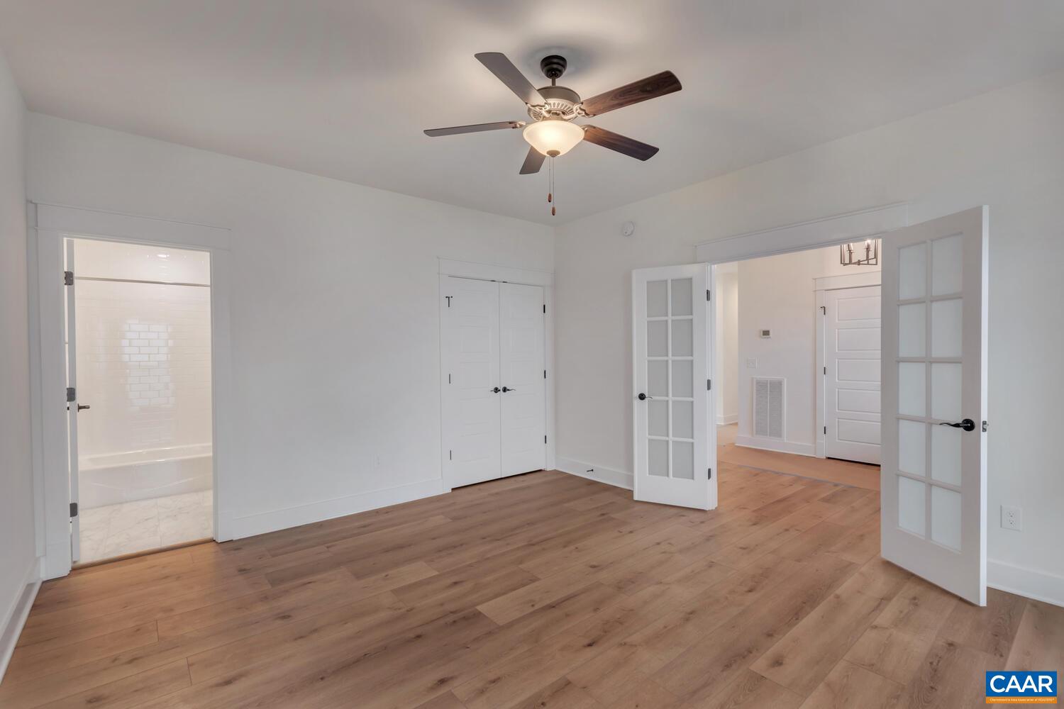 3031 Eagle View Charlottesville, VA 22903 - Photo 9 of 75 an empty room with wooden floor and ceiling fan