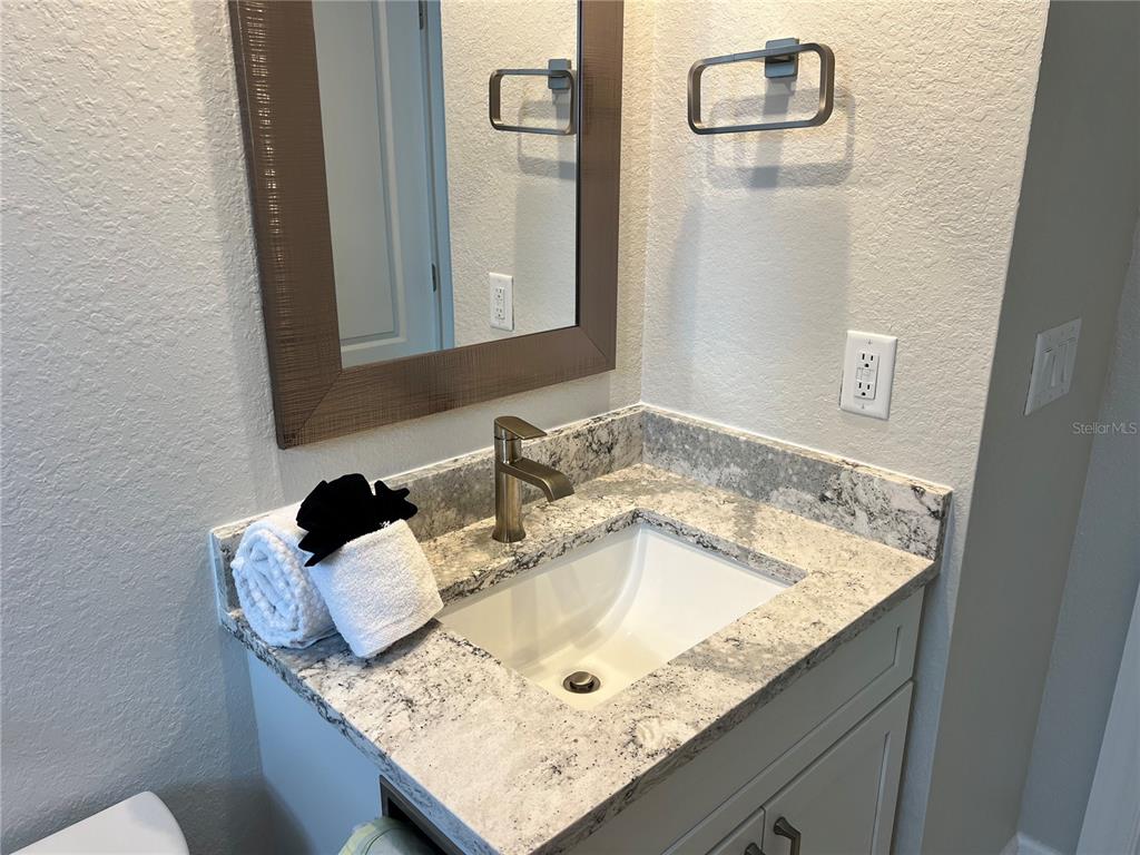 6154 Midnight Pass Road, Unit B14 Sarasota, FL 34242 - Photo 15 of 15 a bathroom with a granite countertop sink and a mirror