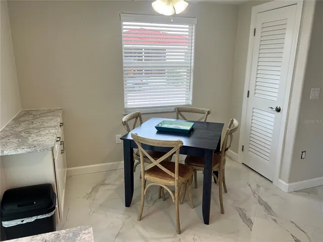 a dining room with furniture and window
