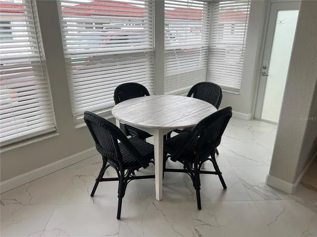 a view of a dining room with furniture and window