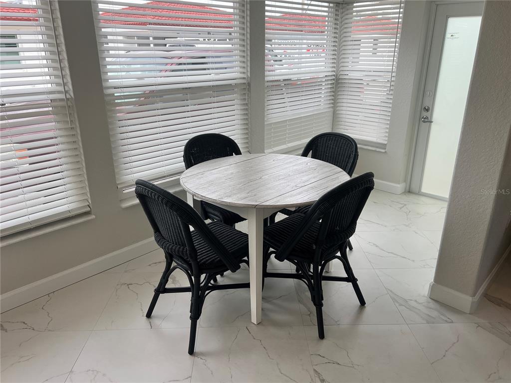 6154 Midnight Pass Road, Unit B14 Sarasota, FL 34242 - Photo 5 of 15 a view of a dining room with furniture and window