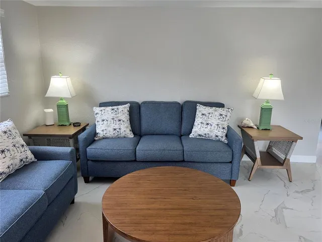 a living room with furniture and a lamp