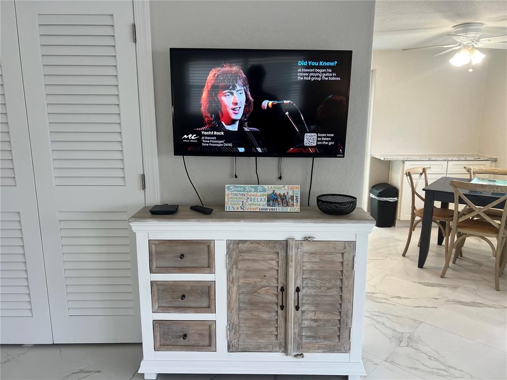 6154 Midnight Pass Road, Unit B14 Sarasota, FL 34242 - Photo 8 of 15 a living room with furniture and a flat screen tv