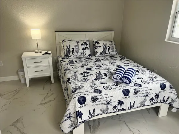 a bedroom with a bed and a chair
