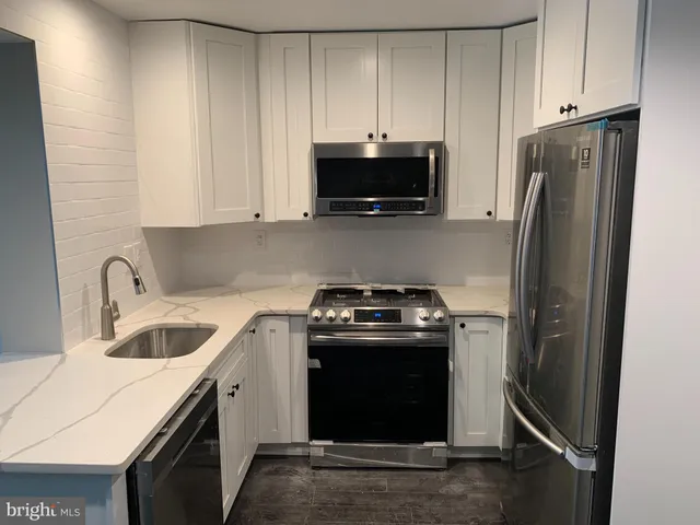a kitchen with a refrigerator stove and microwave