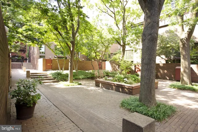 a front view of a house with a yard and a garden