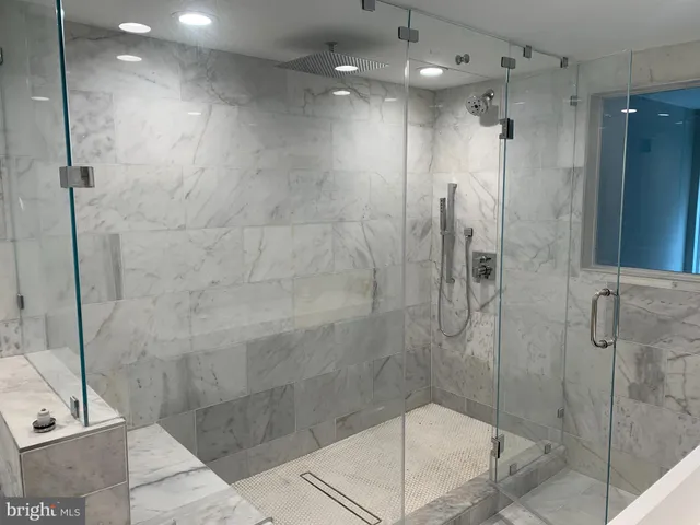 a bath tub sitting next to a white sink and vanity