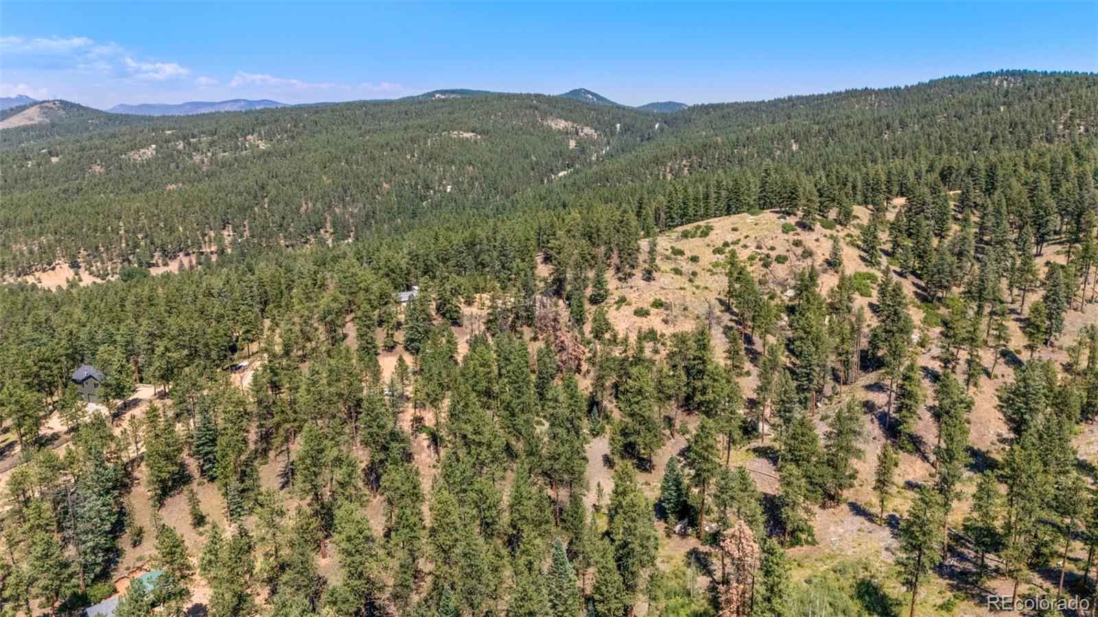12511 West Tina Lane Sedalia, CO 80135 - Photo 12 of 22 a view of a mountain range with lush green forest