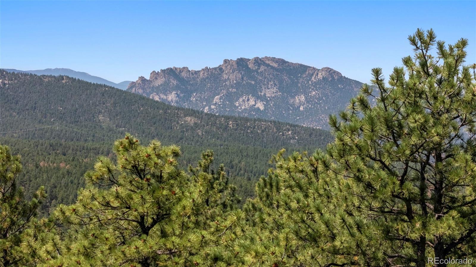 12511 West Tina Lane Sedalia, CO 80135 - Photo 13 of 22 a view of a field with a mountain in the background