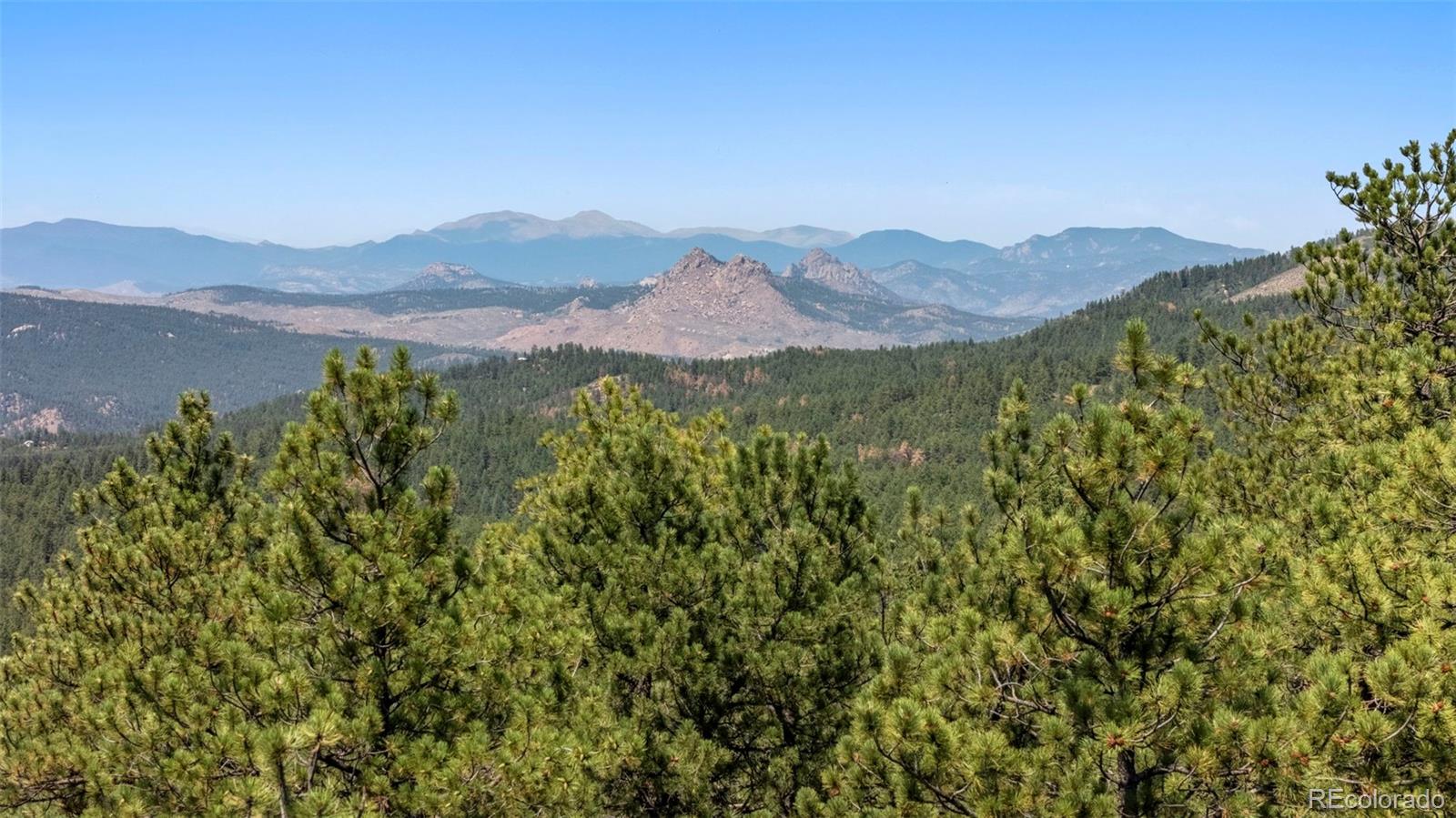 12511 West Tina Lane Sedalia, CO 80135 - Photo 5 of 22 a view of a town with mountains in the background