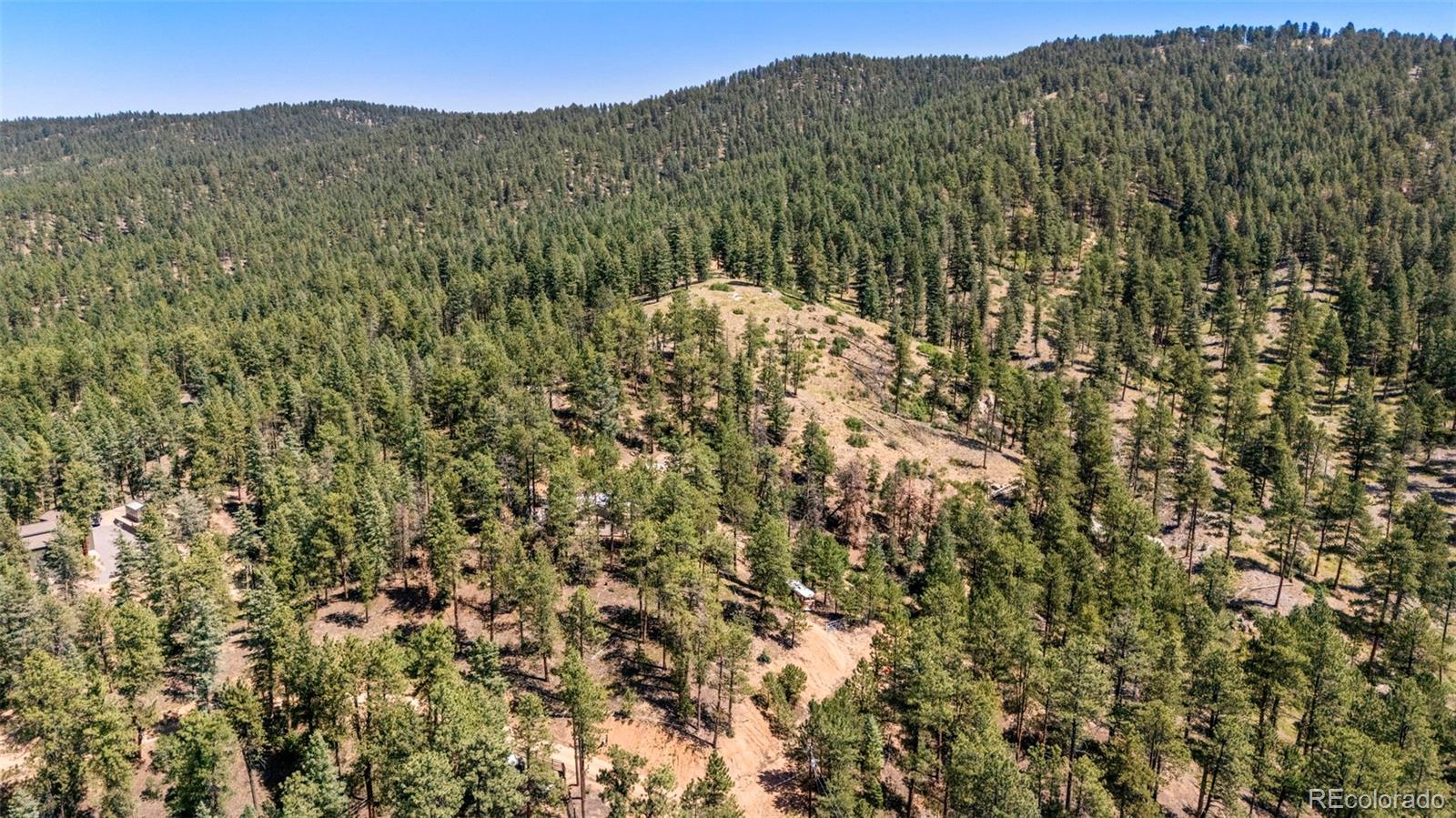 12511 West Tina Lane Sedalia, CO 80135 - Photo 8 of 22 a view of a mountain range with lush green forest