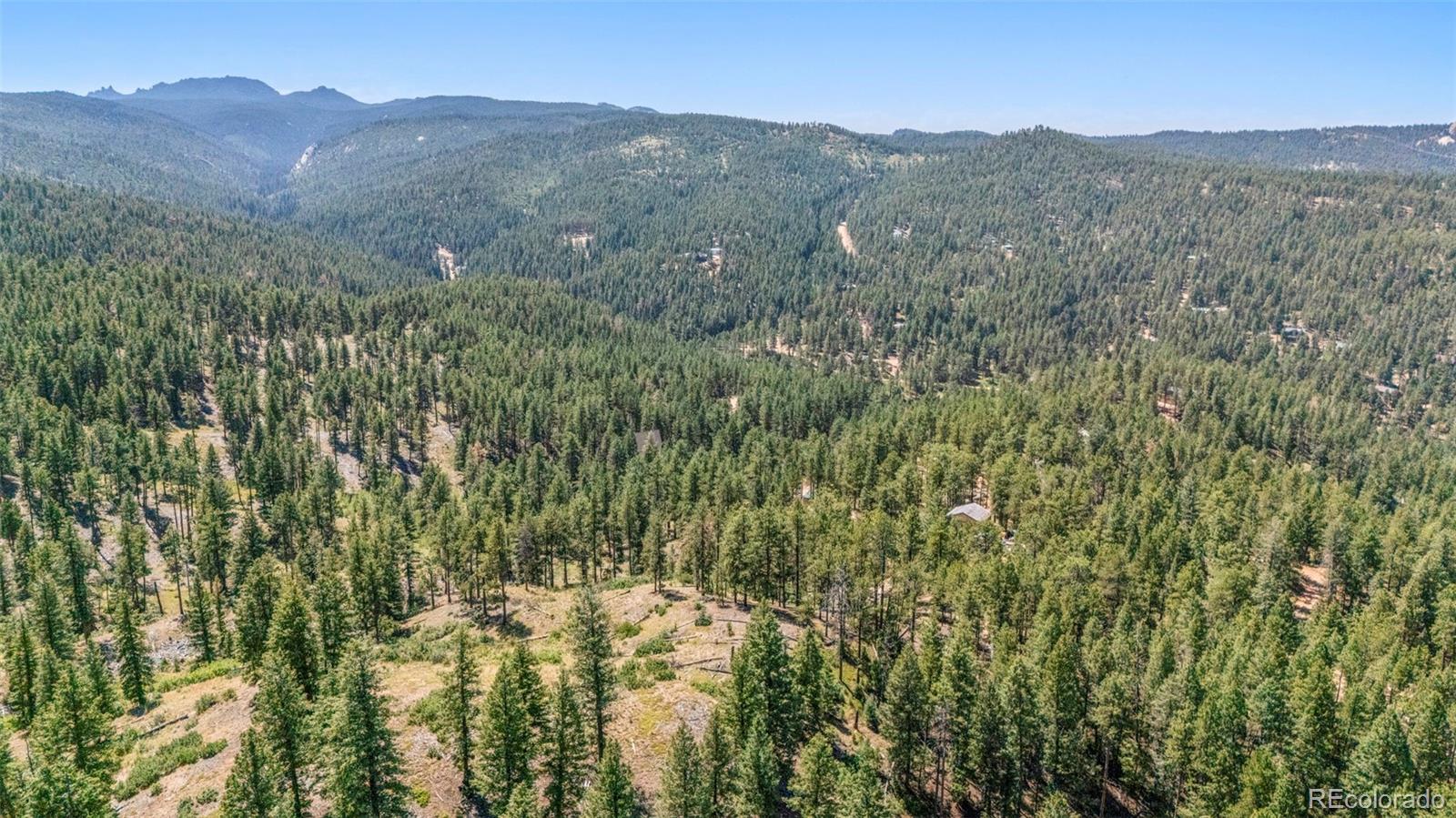12511 West Tina Lane Sedalia, CO 80135 - Photo 10 of 22 a view of a mountain range with trees in the background