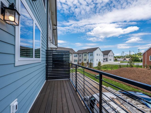 a view of a balcony with wooden floor and city view