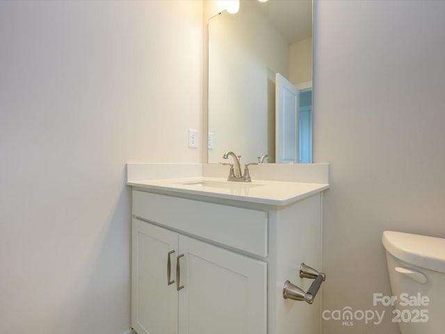 a bathroom with a sink mirror and toilet