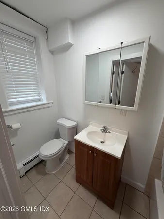 a bathroom with a sink toilet and mirror