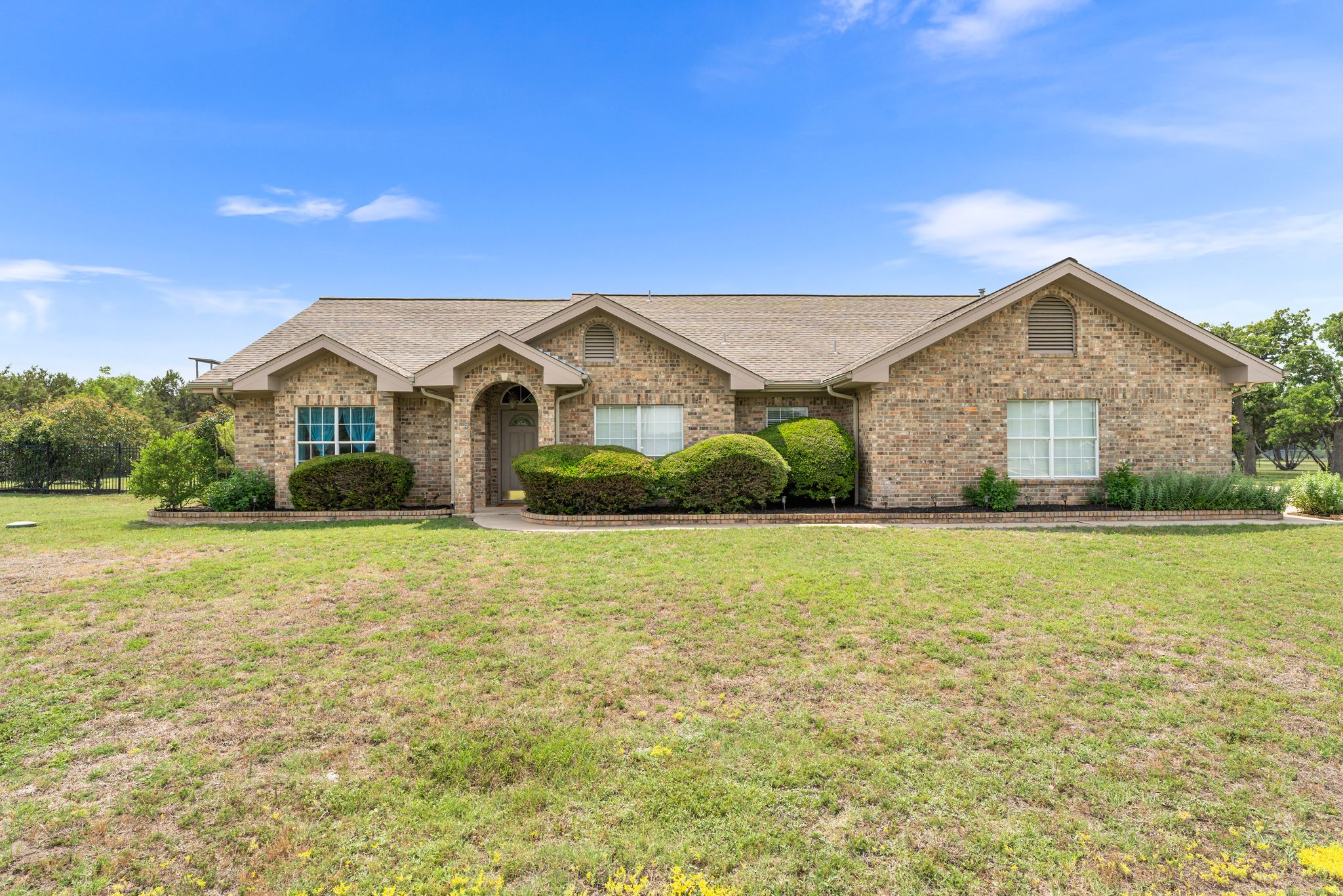221 Breakaway Road Cedar Park, TX 78613 - Photo 1 of 39 Ranch-style home with roof with shingles, a front yard, and brick siding