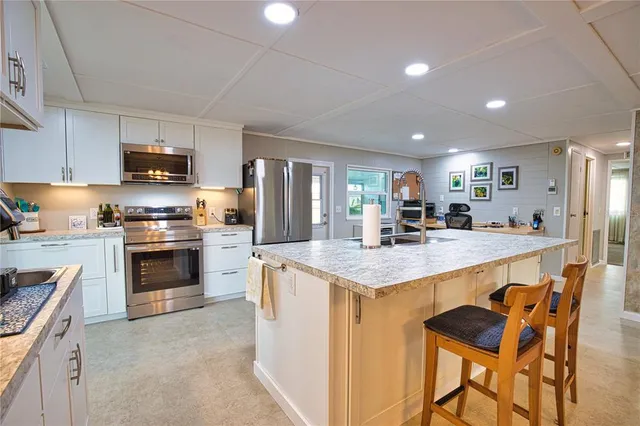 a kitchen that has a lot of cabinets in it