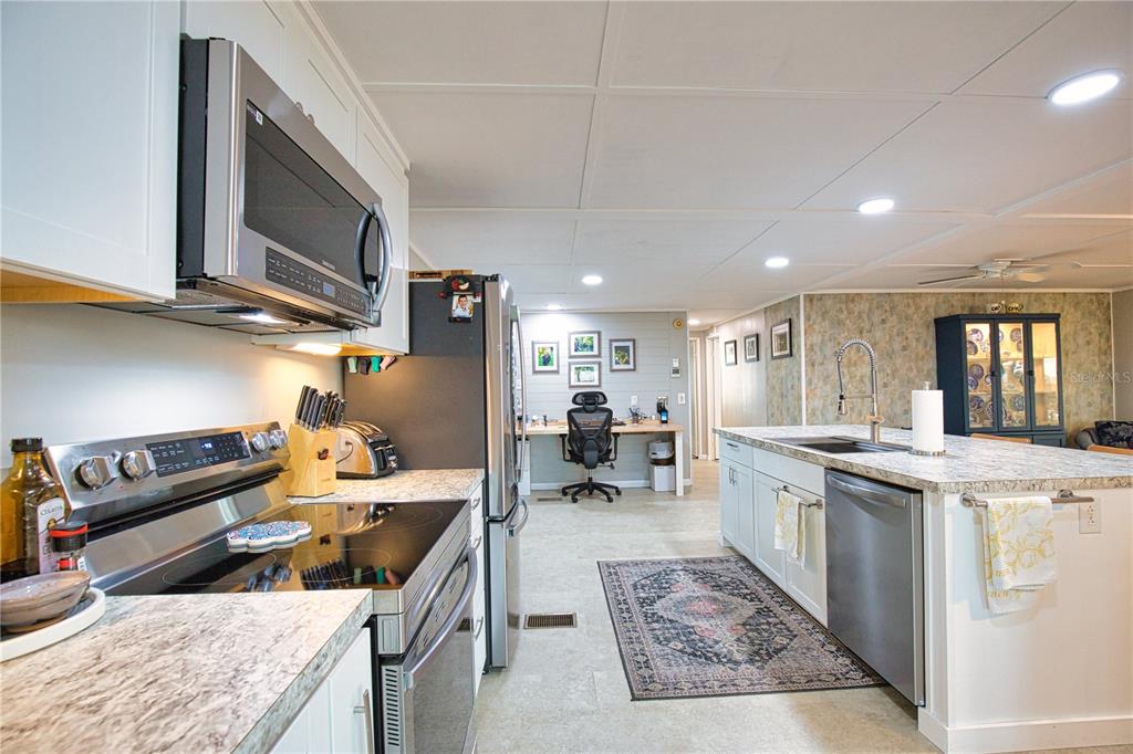 674 El Tango North Port, FL 34287 - Photo 12 of 85 a kitchen with stainless steel appliances granite countertop a sink stove and refrigerator