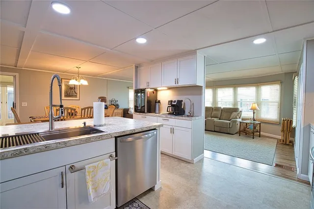 a view of a dining room with furniture a chandelier and wooden floor
