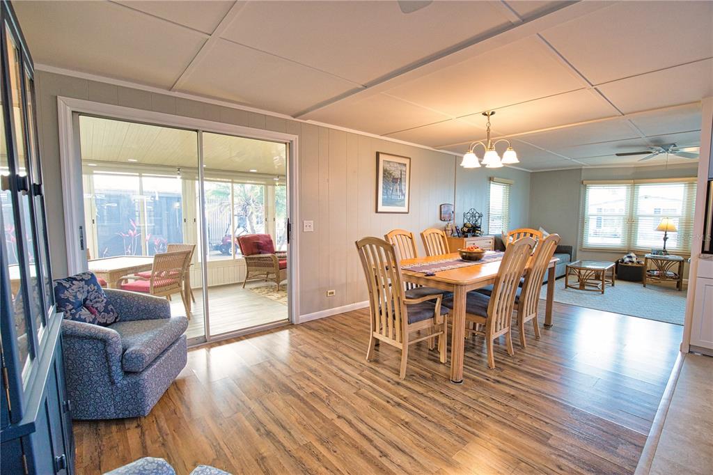 674 El Tango North Port, FL 34287 - Photo 21 of 85 a view of a dining room with furniture a chandelier and wooden floor