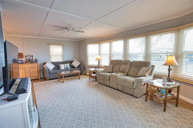a dining room with furniture window and wooden floor